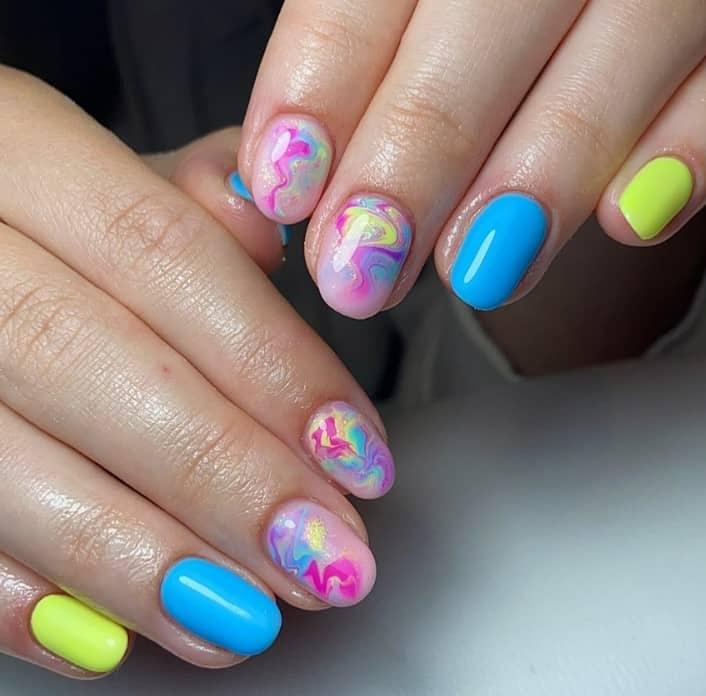 a woman with touch of pink and purple in the accent nails of your blue-and-yellow mani