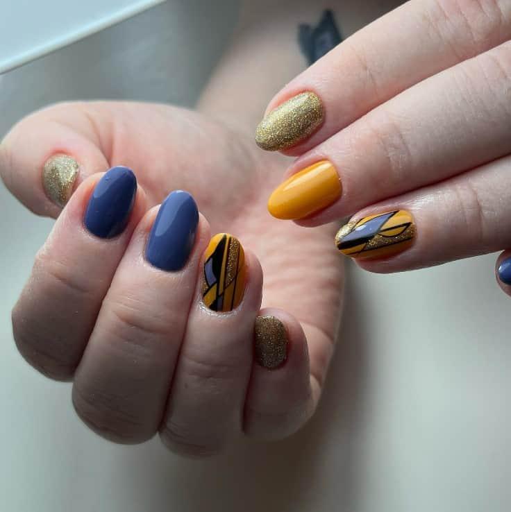 a woman with glossy blue and yellow gel nails look elegant with gold glitter and art deco-inspired designs on the accent nails