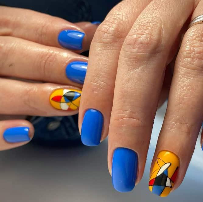 a blue manicure with a stunning yellow art accent nail