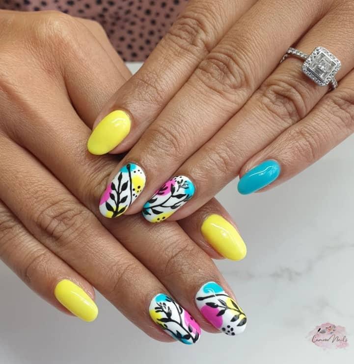 white base and touches of blue, yellow, and hot pink make the abstract leaves on the accent nails pop