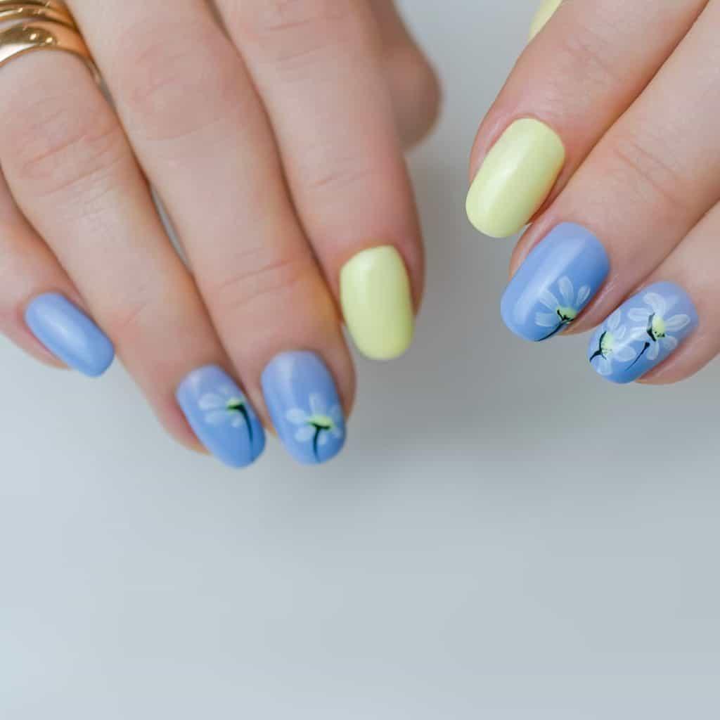 a woman's nails with cute pale blue nails with simple white daisy nail art and add a sunshine yellow accent