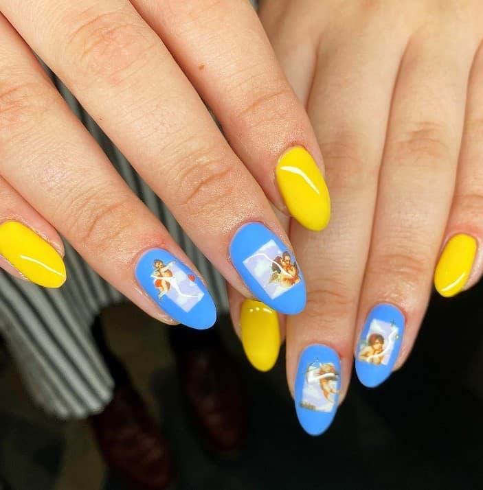 bright blue nails with hand-painted clouds and classic cherub art stickers