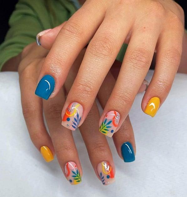 yellow-and-blue manicure to showcase abstract leaves and geometric designs