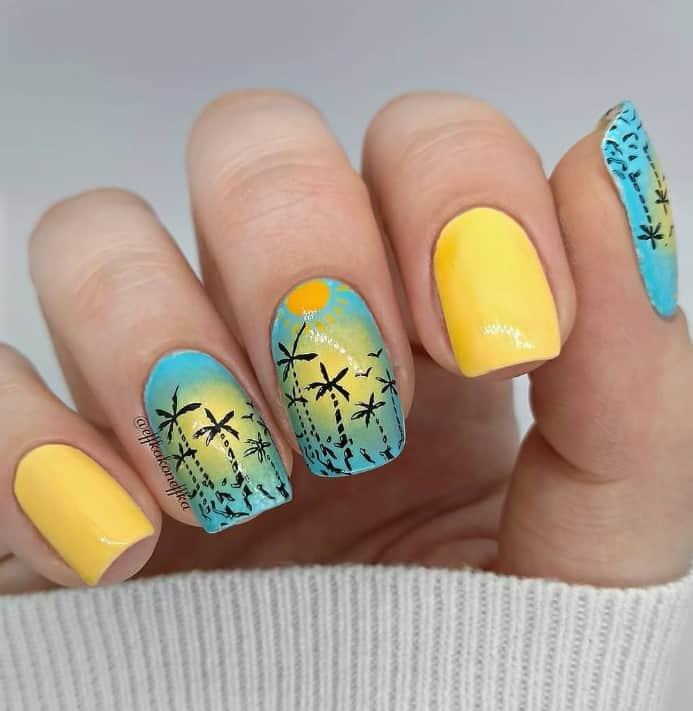 pretty silhouette of palm trees with a diffused vignette on sky blue nails, then pair them with sunny yellow nails