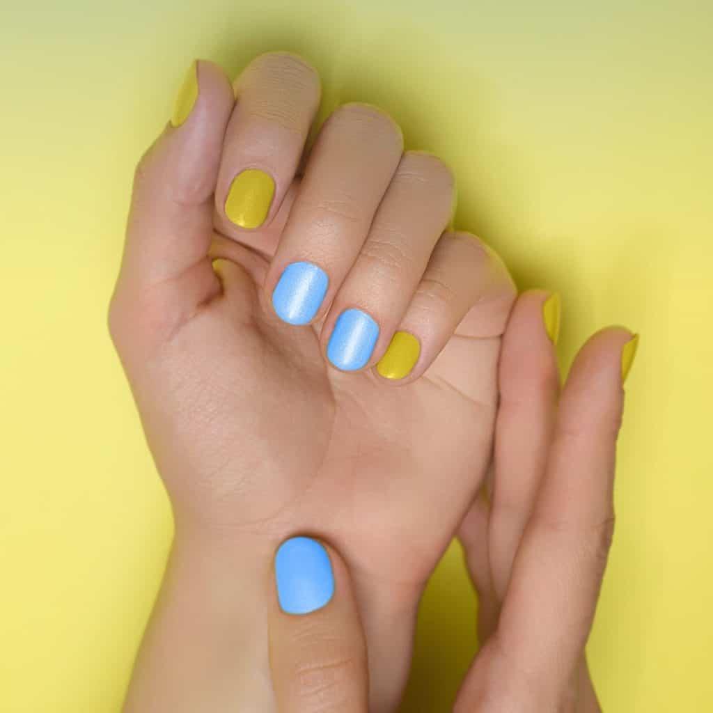 a simple blue and yellow nail polish with frosty and glittery finish