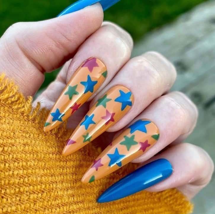 a woman with long pointed nails with stars designs as accent