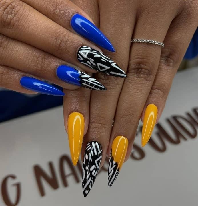 bright blue and yellow stiletto manicure with bold white lines and triangles
