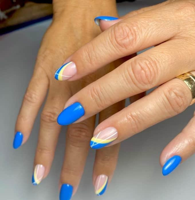 bright cobalt blue nails with unique accent nails that have two-toned French tips in sunny yellow and white