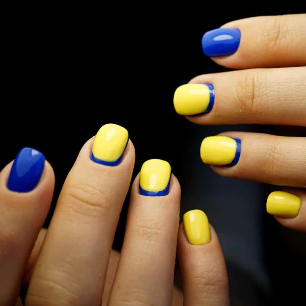 bright lemon yellow nails paired with blue glossy accent nails