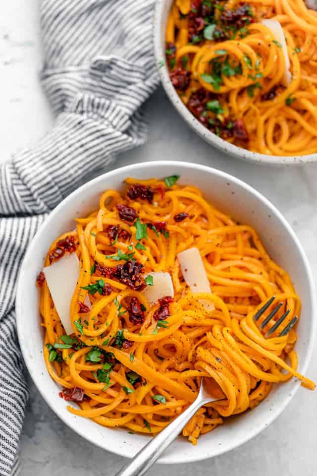 Butternut squash noodles with sun-dried tomatoes, parsley, and Parmesan cheese