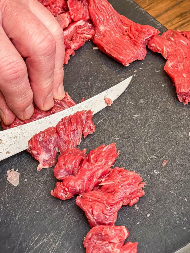flap meat being sliced for stir fry