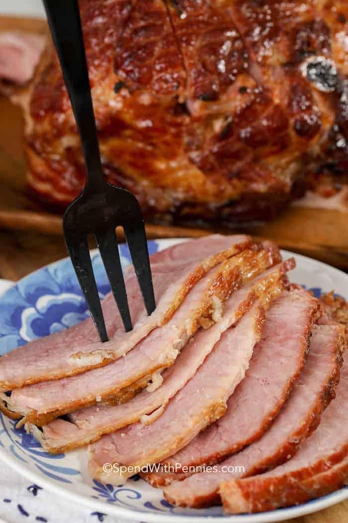 Slices of Baked Ham with Brown Sugar Glaze on a plate with a fork