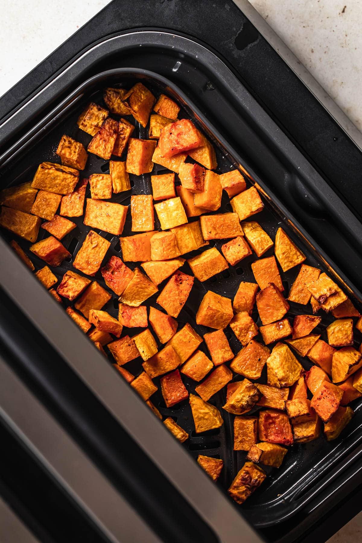 Diced roasted butternut squash in air fryer.