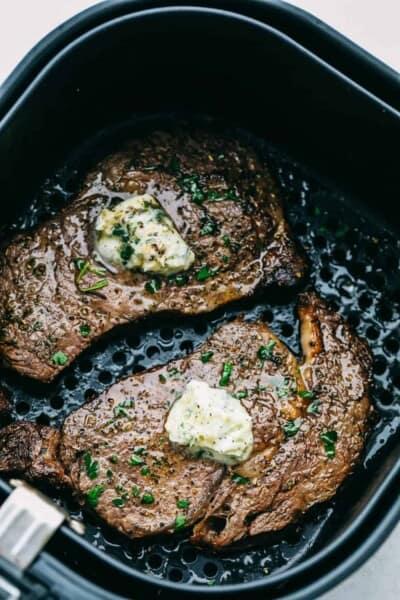 Perfect Air Fryer Steak with golden seared outside and tender juicy inside. Topped with garlic butter.