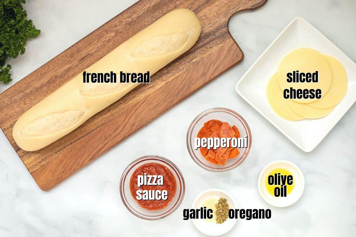 Ingredients for Air Fryer French Bread Pizza labeled on counter.