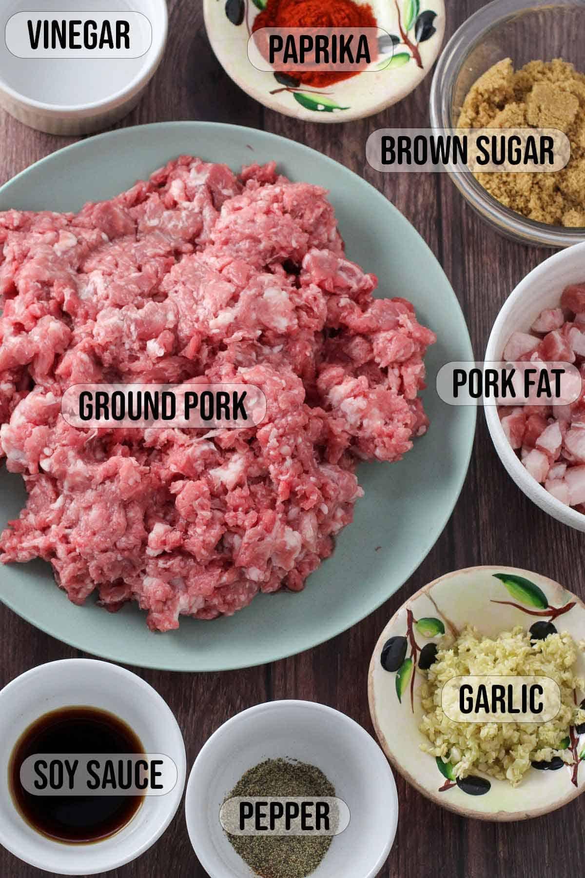 ground pork, ground pork fat, garlic, soy sauce, pepper, paprika, brown sugar, vinegar in bowls
