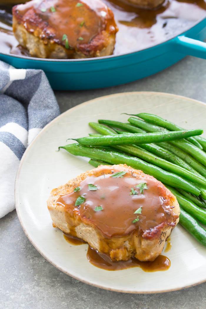 Pan-seared pork chops with honey mustard sauce, served with green beans.