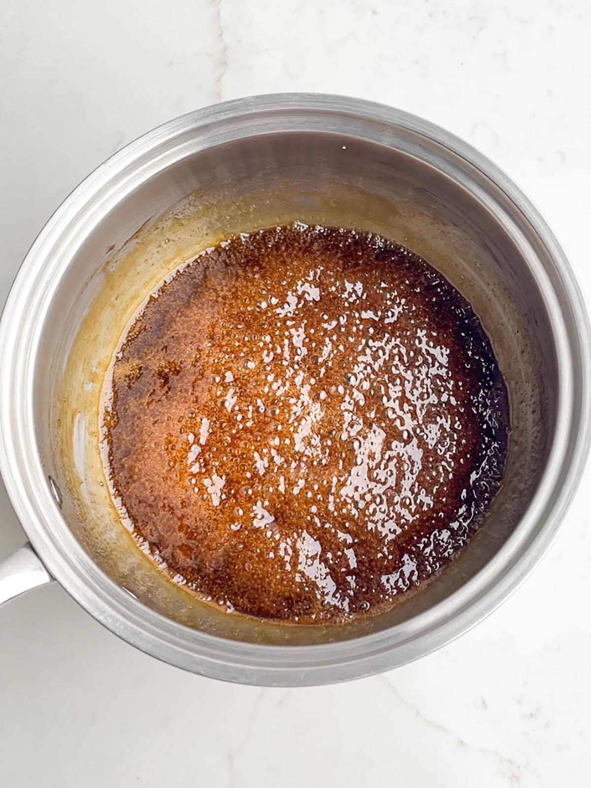 brown sugar pineapple glaze simmering in a saucepan