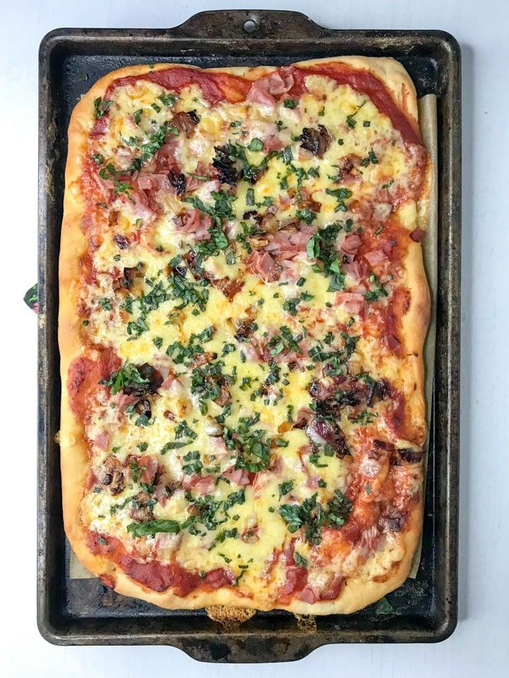 pizza cooling on a baking sheet