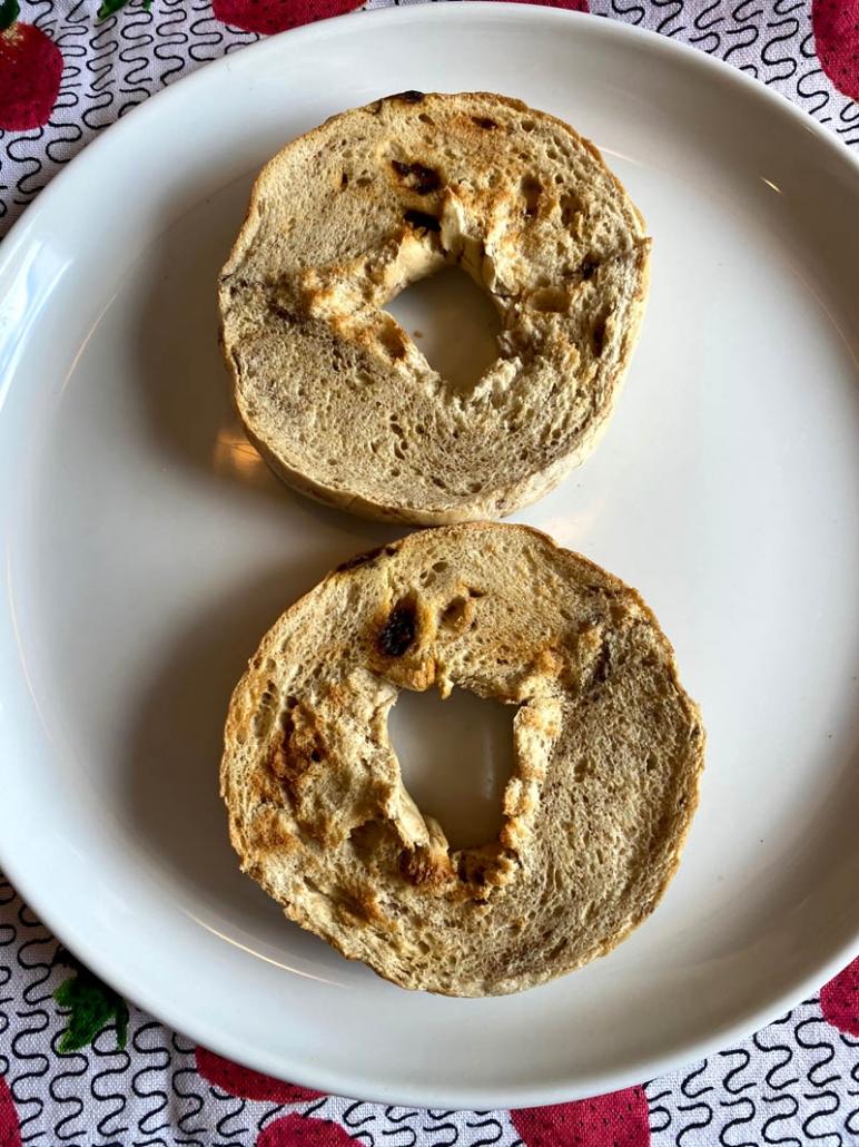 Toasted Bagel Halves on a White Plate