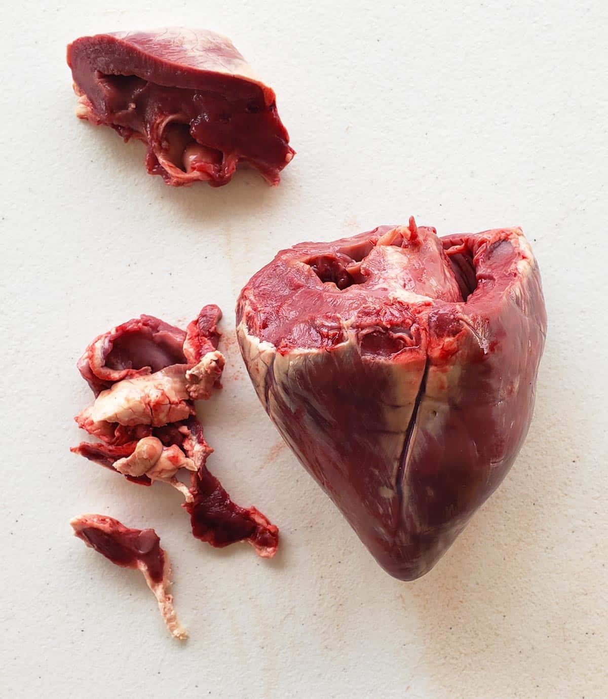 A deer heart trimmed at the top, with the hard fat removed from the outside.