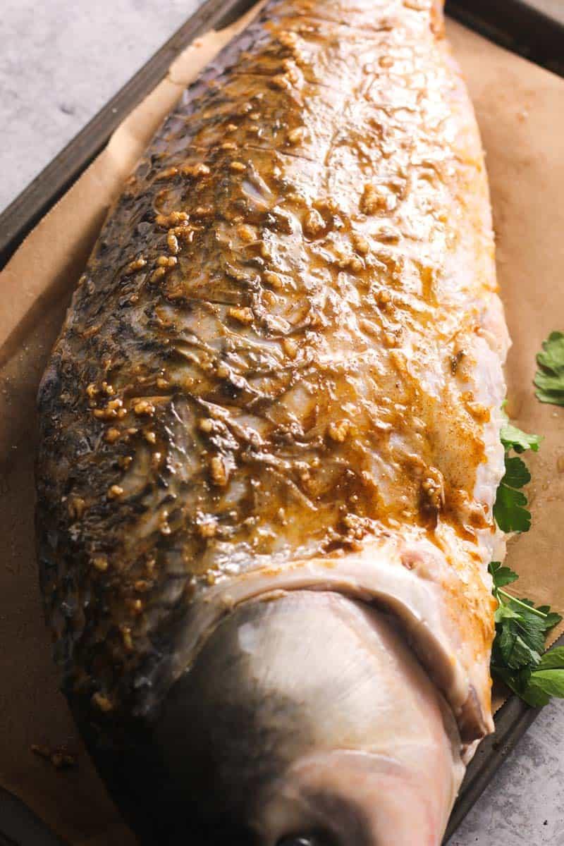 preparing whole fish with garlic butter