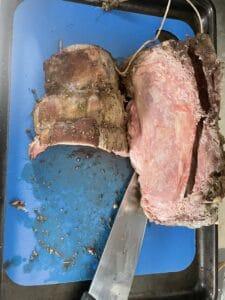 Cutting cross rib roast on a blue cutting board
