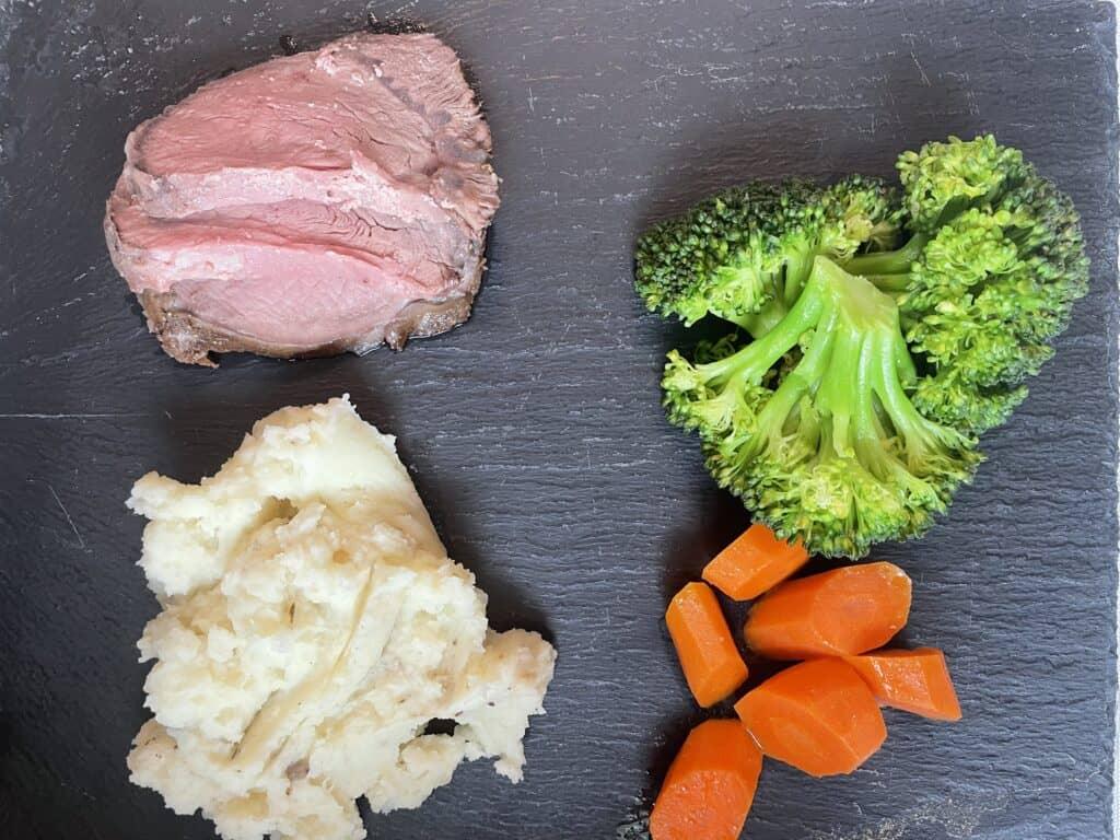 A roast beef dinner on a plate