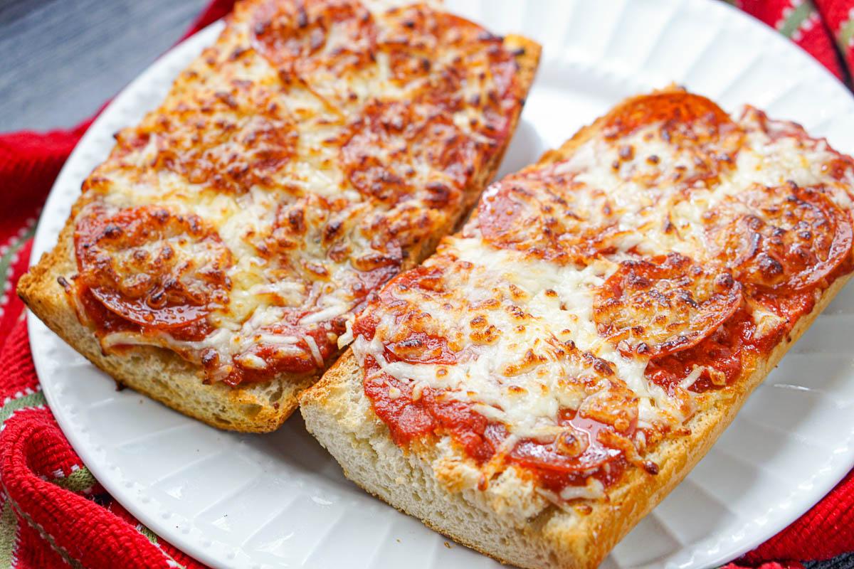 closeup of 2 pieces of French bread pizzas