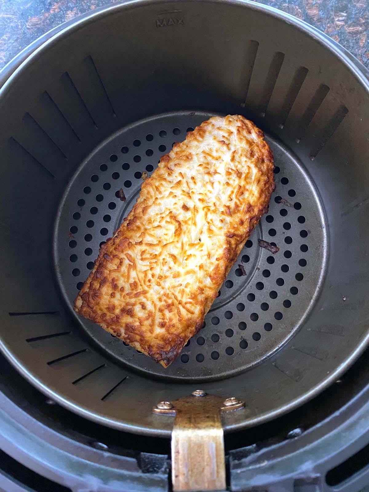 Cooked French bread pizza in an air fryer.