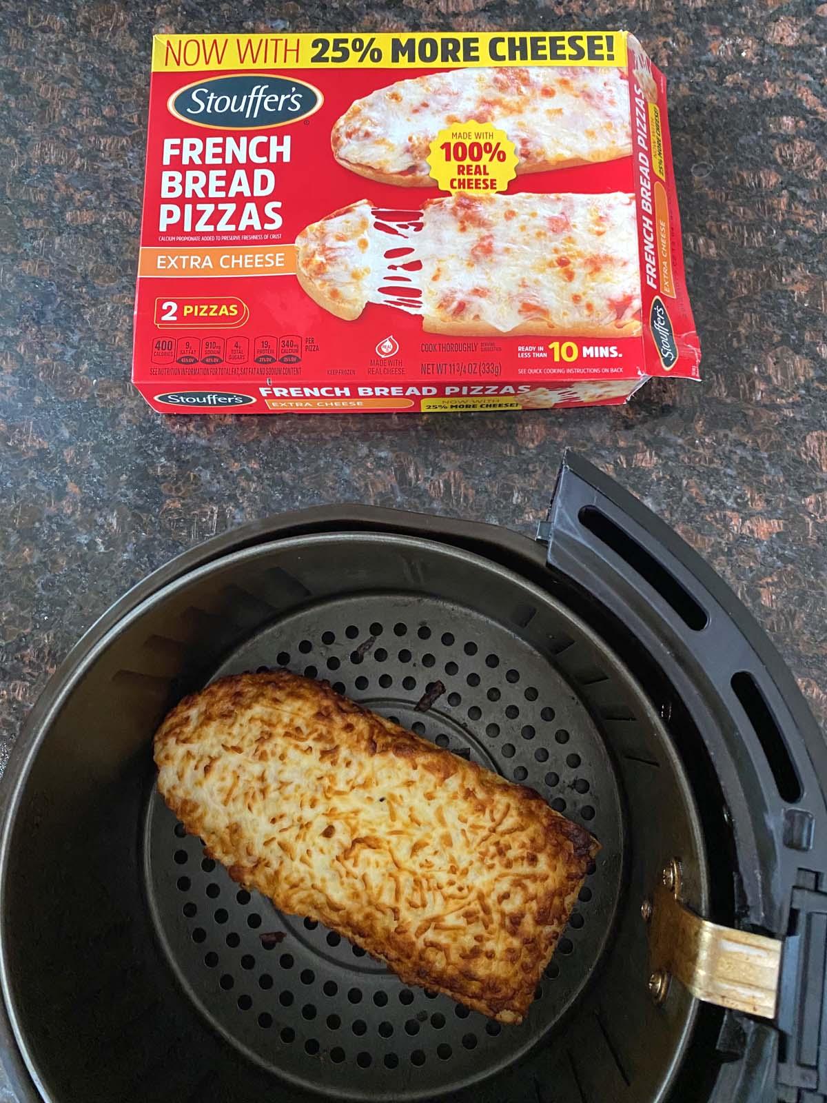 Box of French bread pizza in front of an air fryer.