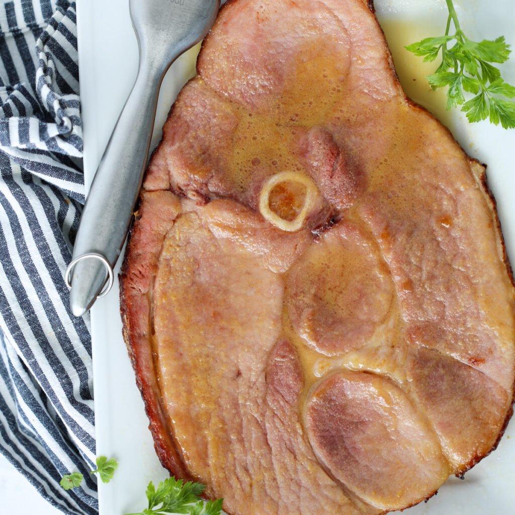 ham steak in air fryer brushed with sauce close up image