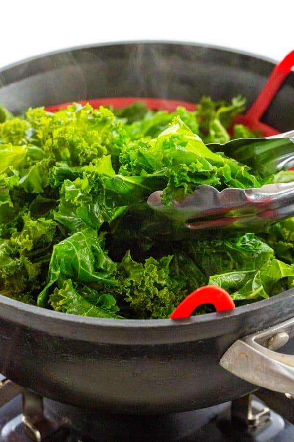 cooking steamed kale on the stovetop