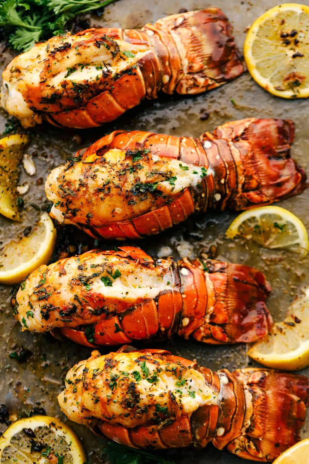 Lobster tails broiled on a sheet pan.