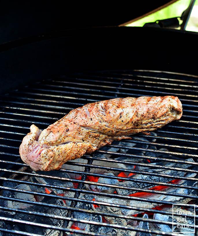 pork tenderloin grilling on a grill