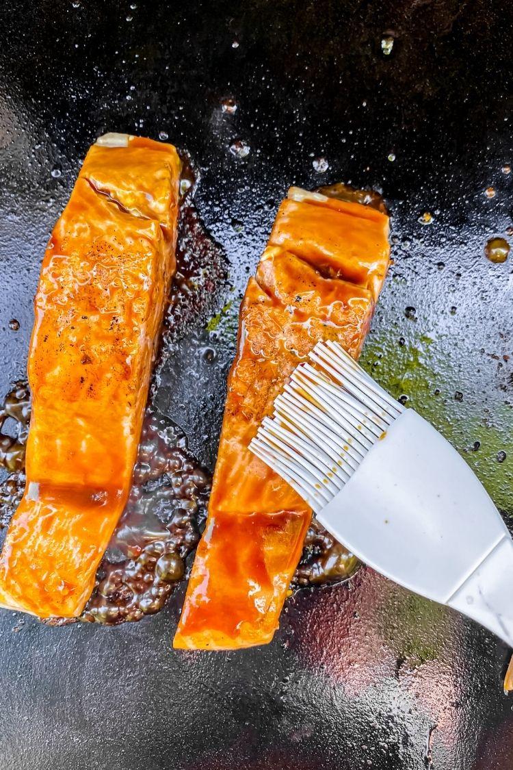 salmon on the Blackstone basting with paleo teriyaki sauce