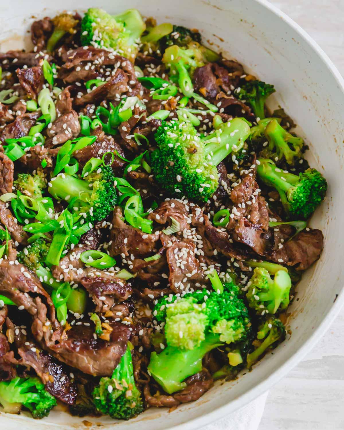 Beef shaved steak stir fry with broccoli, stir fry sauce, and sesame seeds.