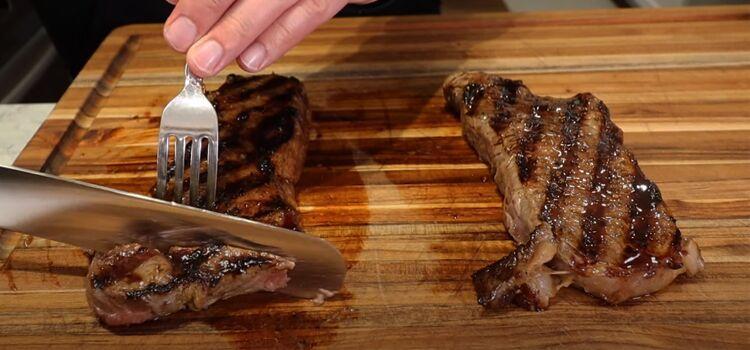 slicing steak on a wooden board