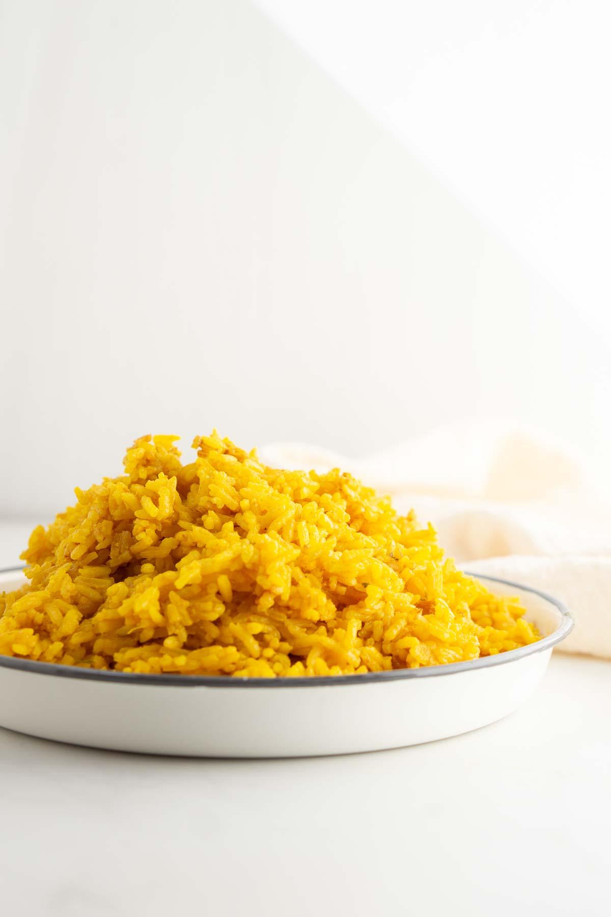 Turmeric rice in a pile on a plate ready to be served