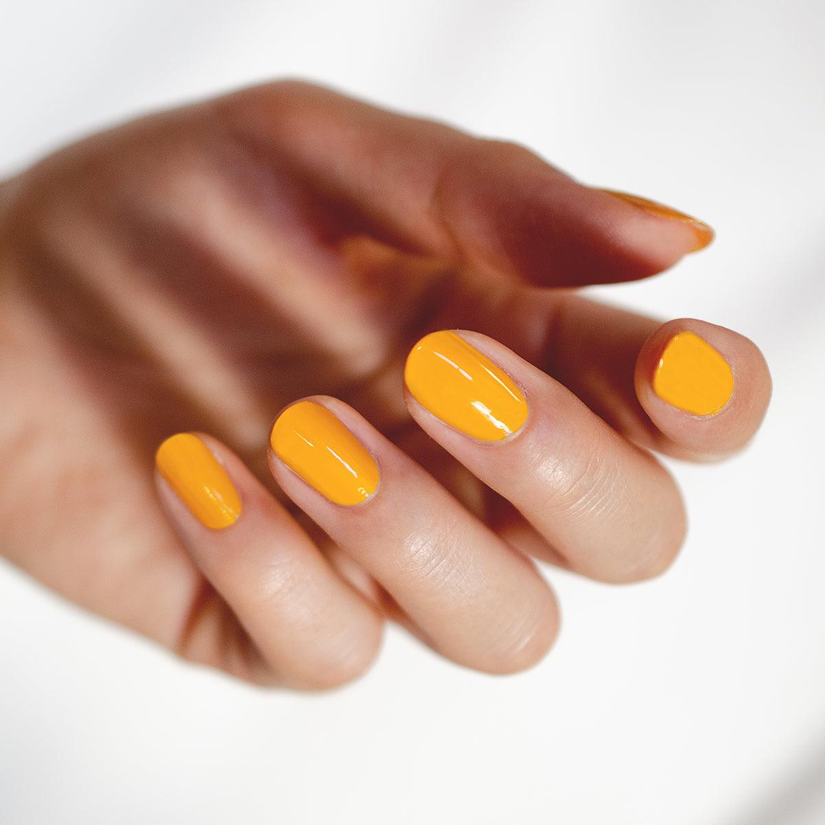 Round nail shape with yellow nail polish