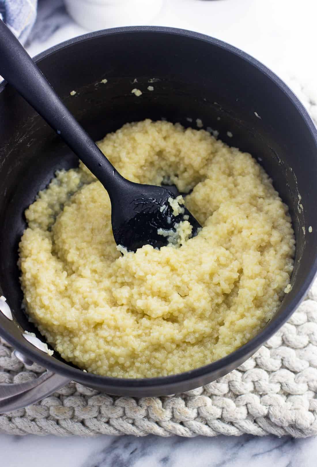 Pastina cooked in broth in a saucepan before adding the butter and milk