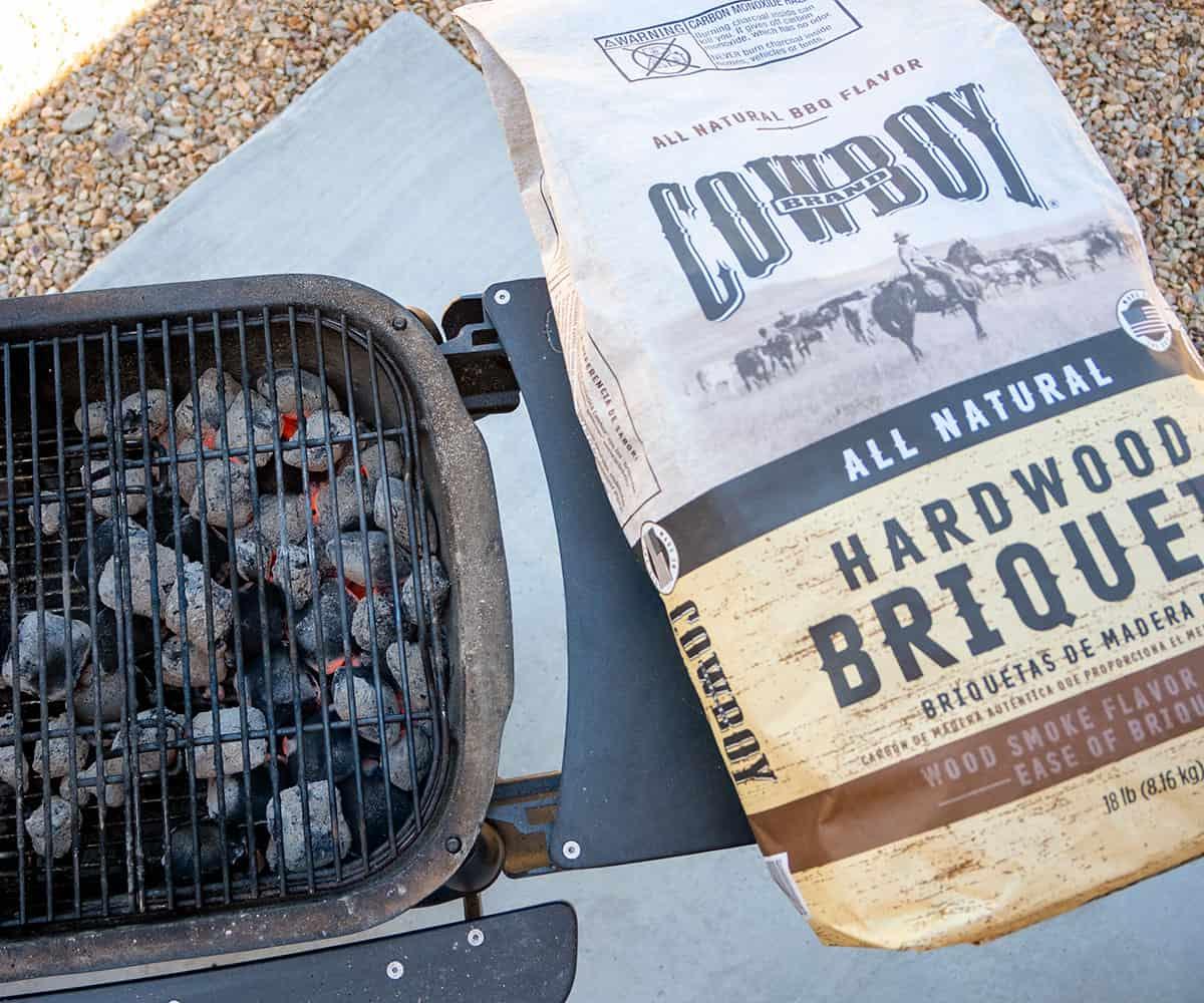 bag of cowboy charcoal by grill.