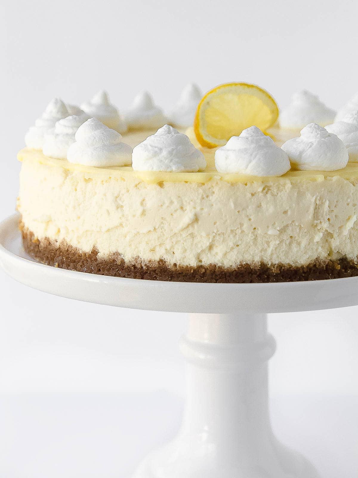 Lemon cheesecake on a cake stand.