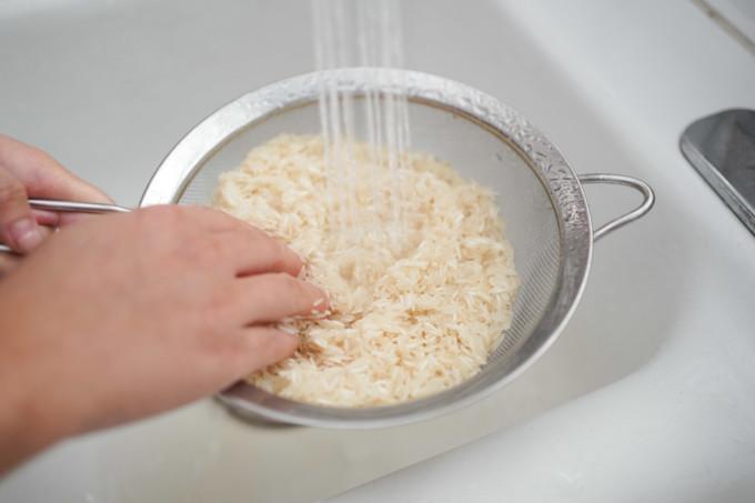 Rinsing basmati rice in the sink