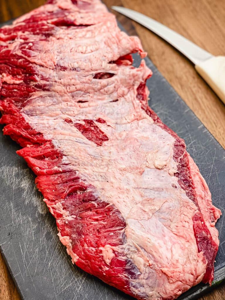 untrimmed flap meat on a cutting board