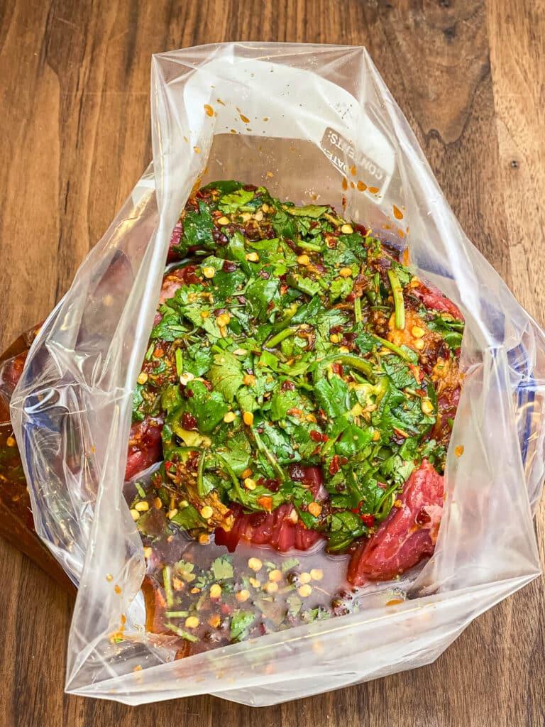 flap meat in a bag covered with marinade