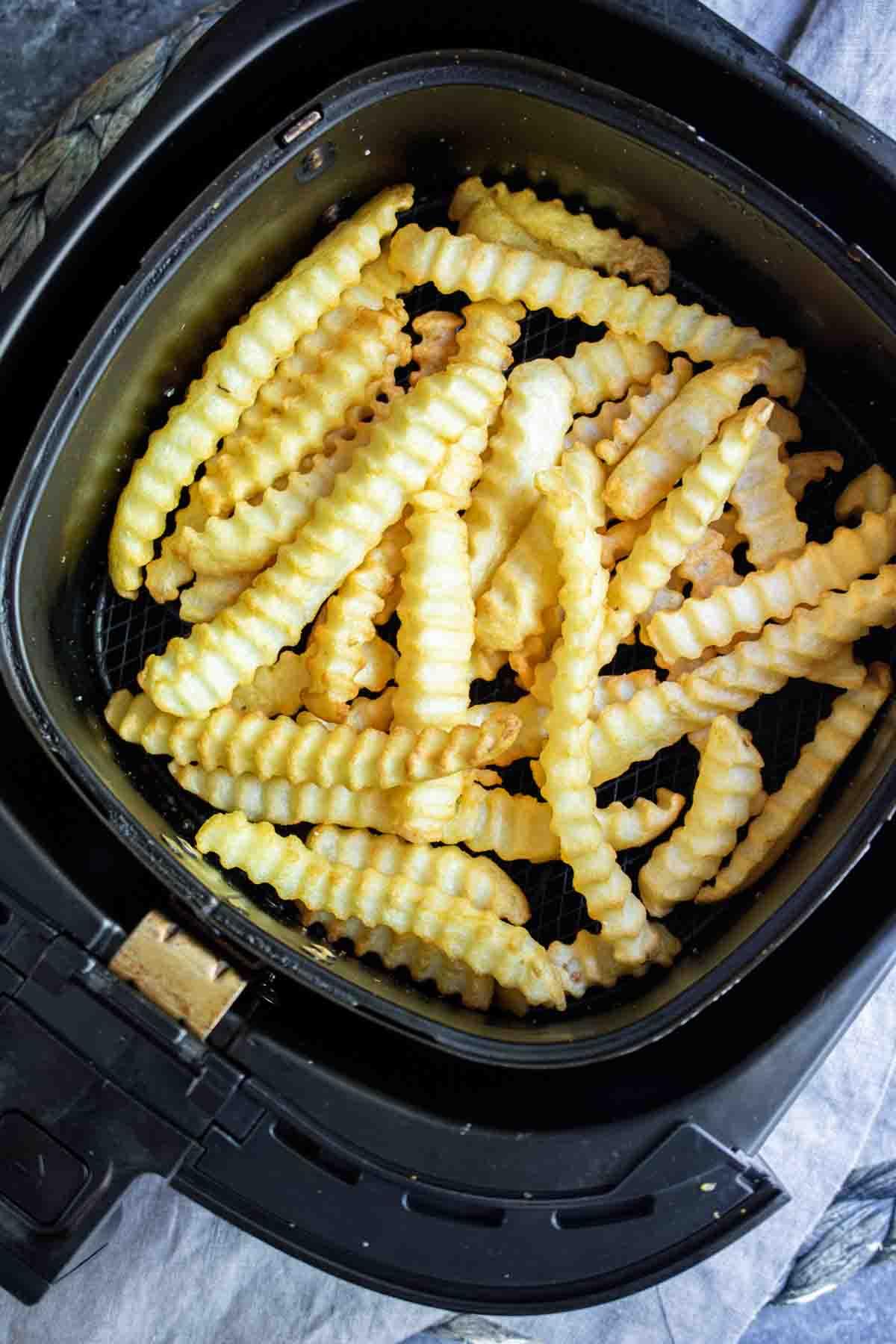 Crinkle Air Fryer Frozen French Fries in air fryer basket
