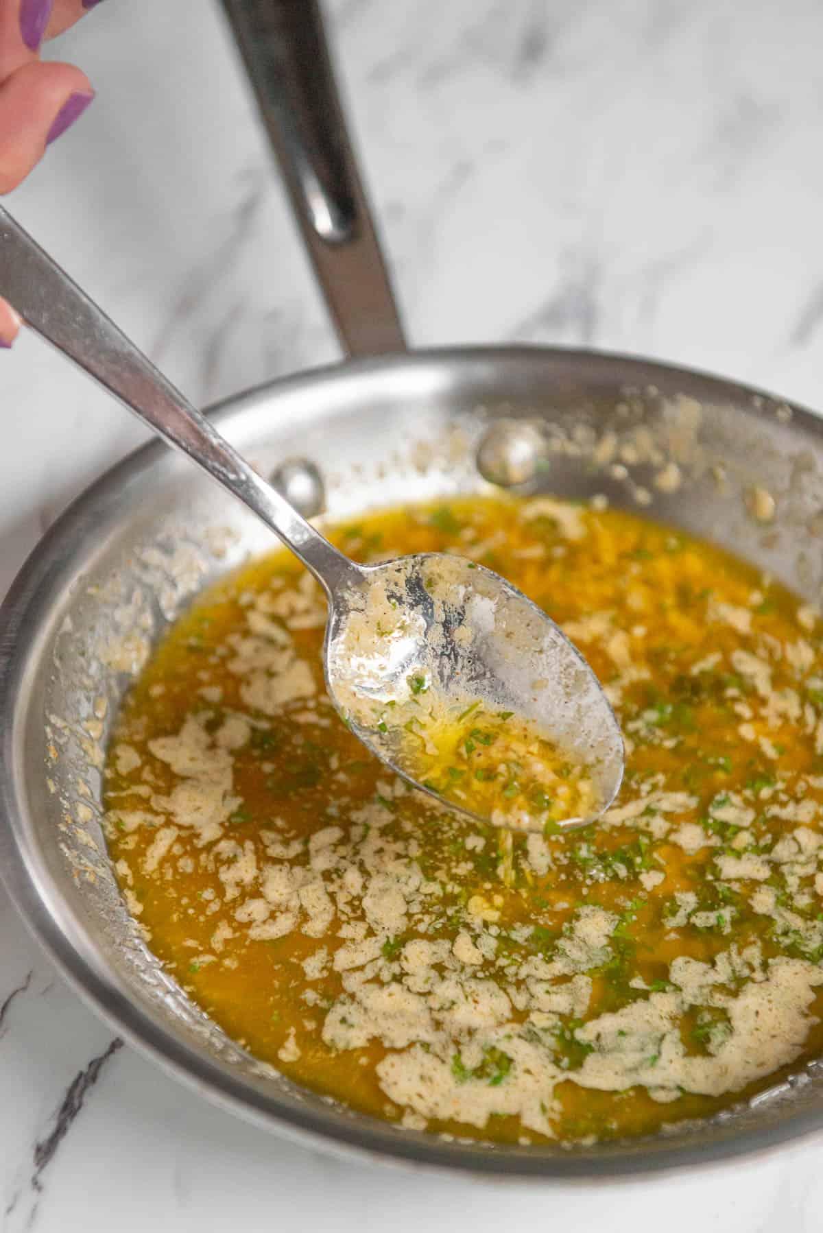 melted garlic herb butter in saucepan.