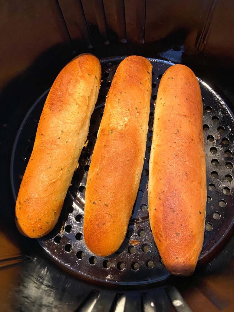 close up of frozen bread sticks in the air fryer