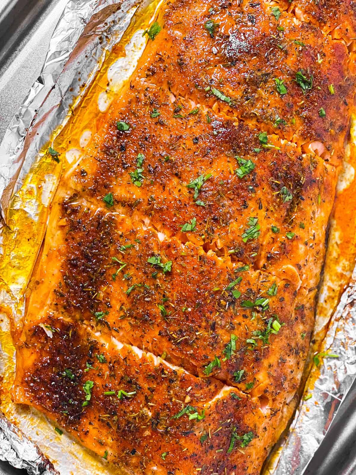 overhead view of oven baked salmon fillet cut into pieces